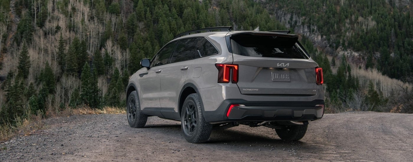 Rear of a grey 2026 Kia Sorento parked off-road.