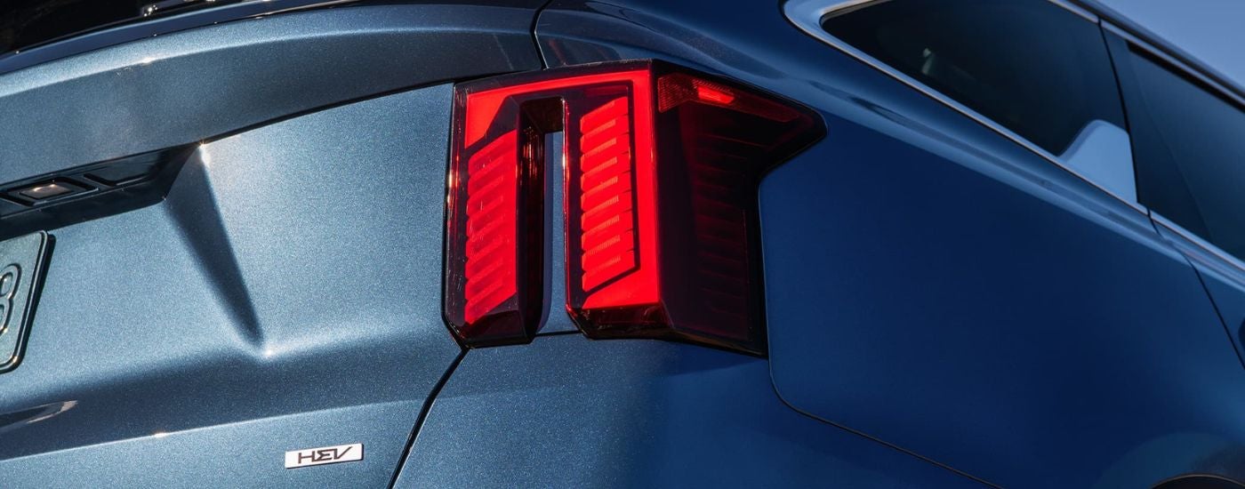 Close-up on the taillight of a blue 2026 Kia Sorento Hybrid.