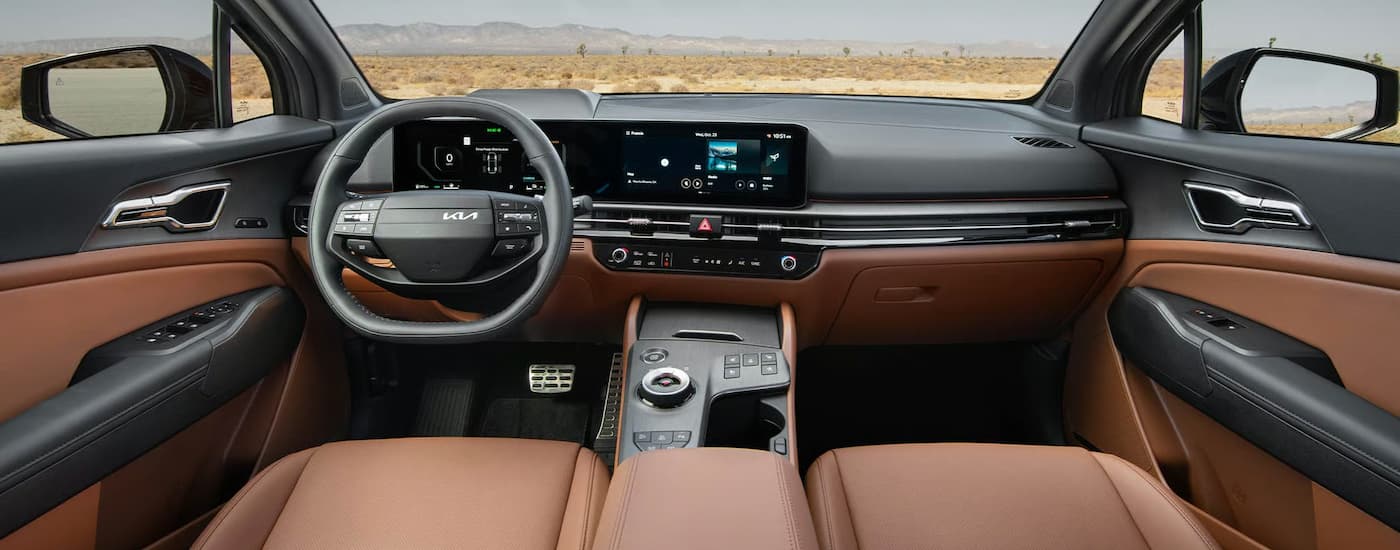 The steering wheel and dashboard inside of a 2026 Kia Sportage.