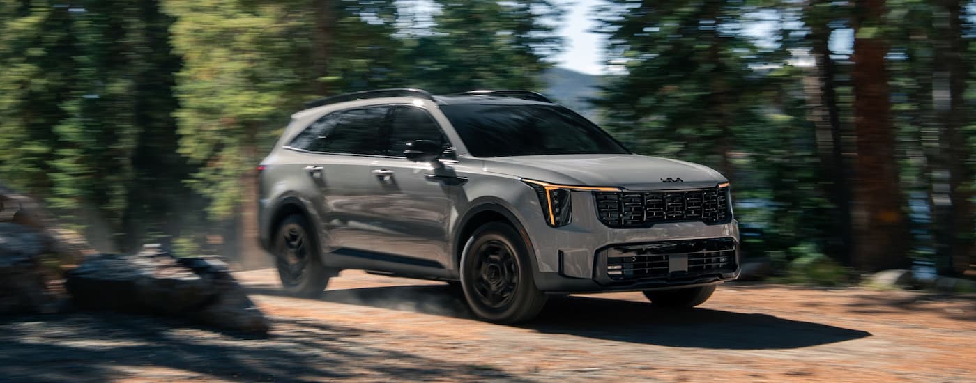 Grey 2026 Kia Sportage X-Pro SX Prestige driving off-road.