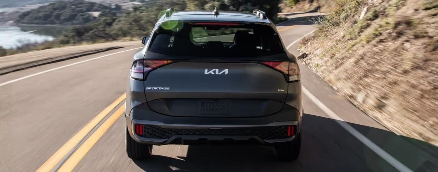 Grey 2023 Kia Sportage X-Line driving on a highway.