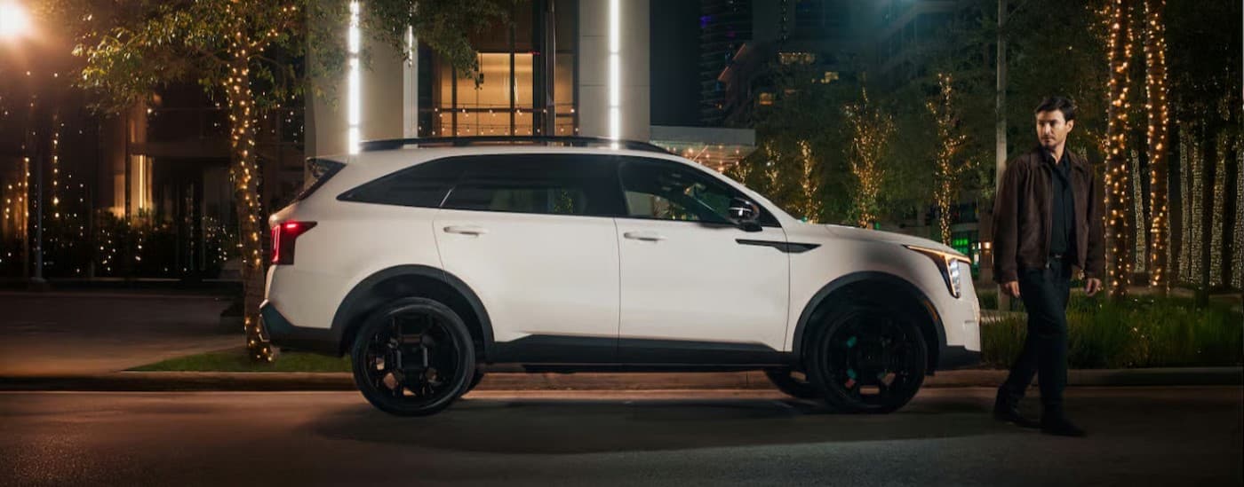 A white 2025 Kia Sorento for sale parked in a city.