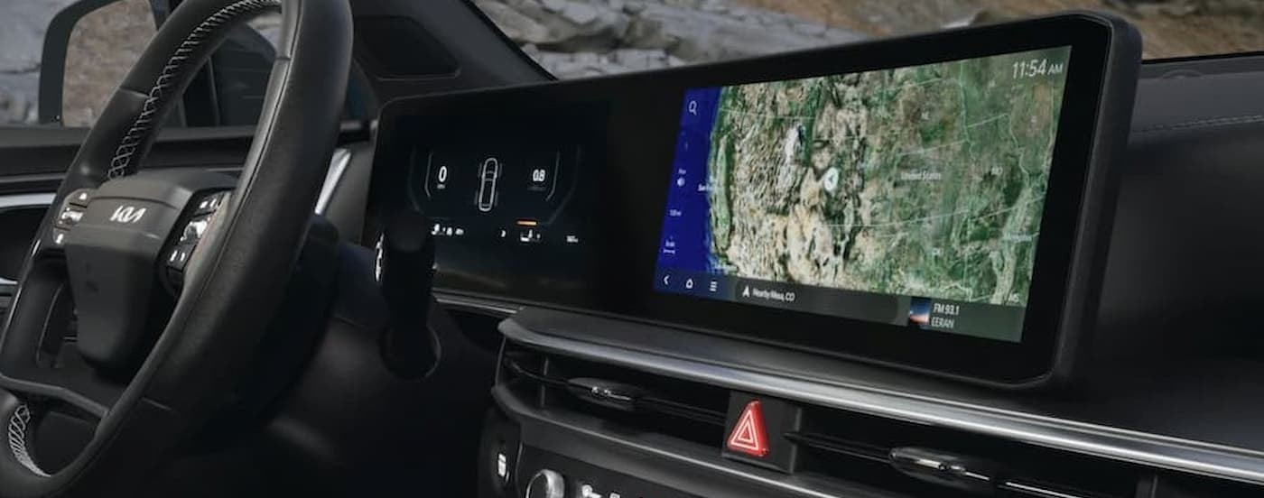 Close-up of the steering wheel and infotainment screen in a 2026 Kia Sorento.