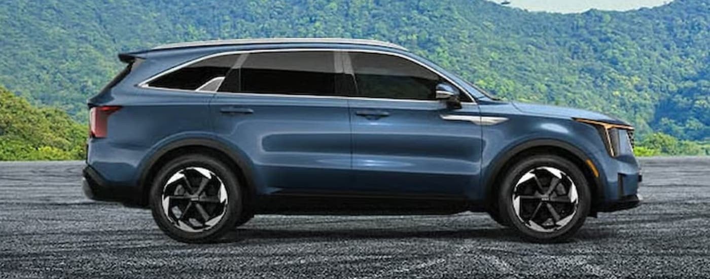 A blue 2026 Kia Sorento parked offroad.