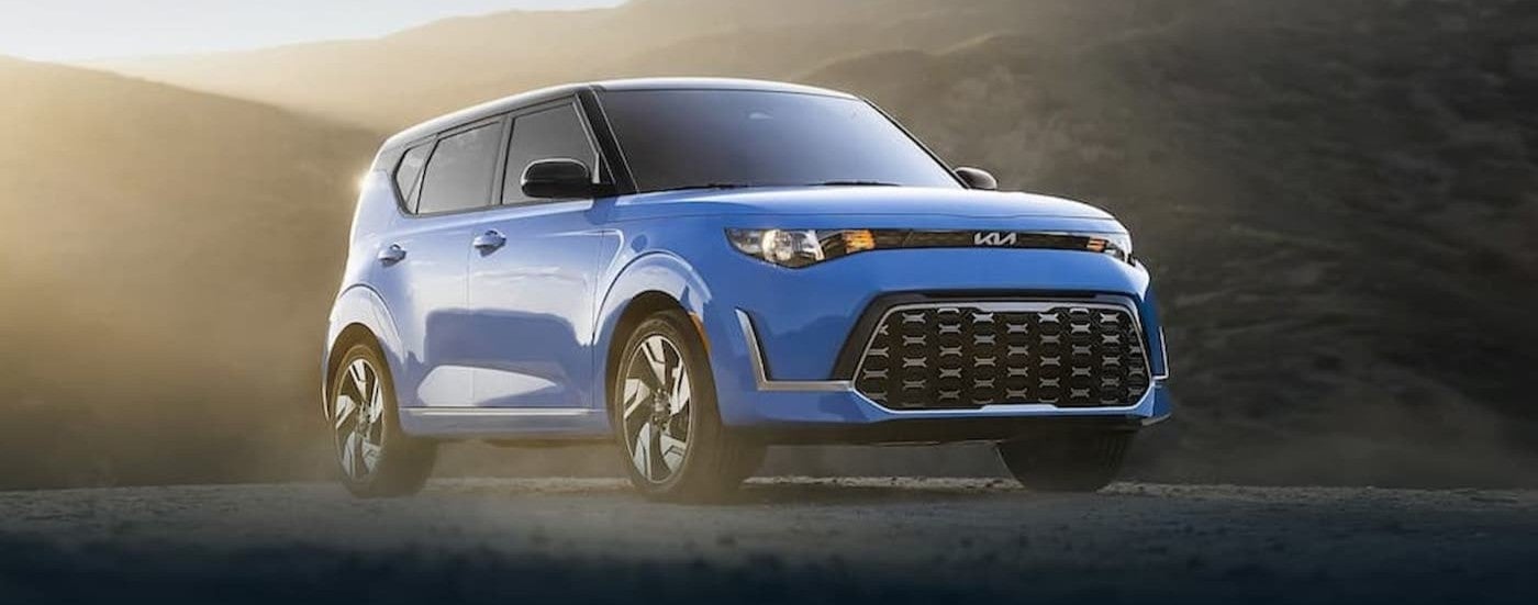 A blue 2022 Kia Soul parked offroad.