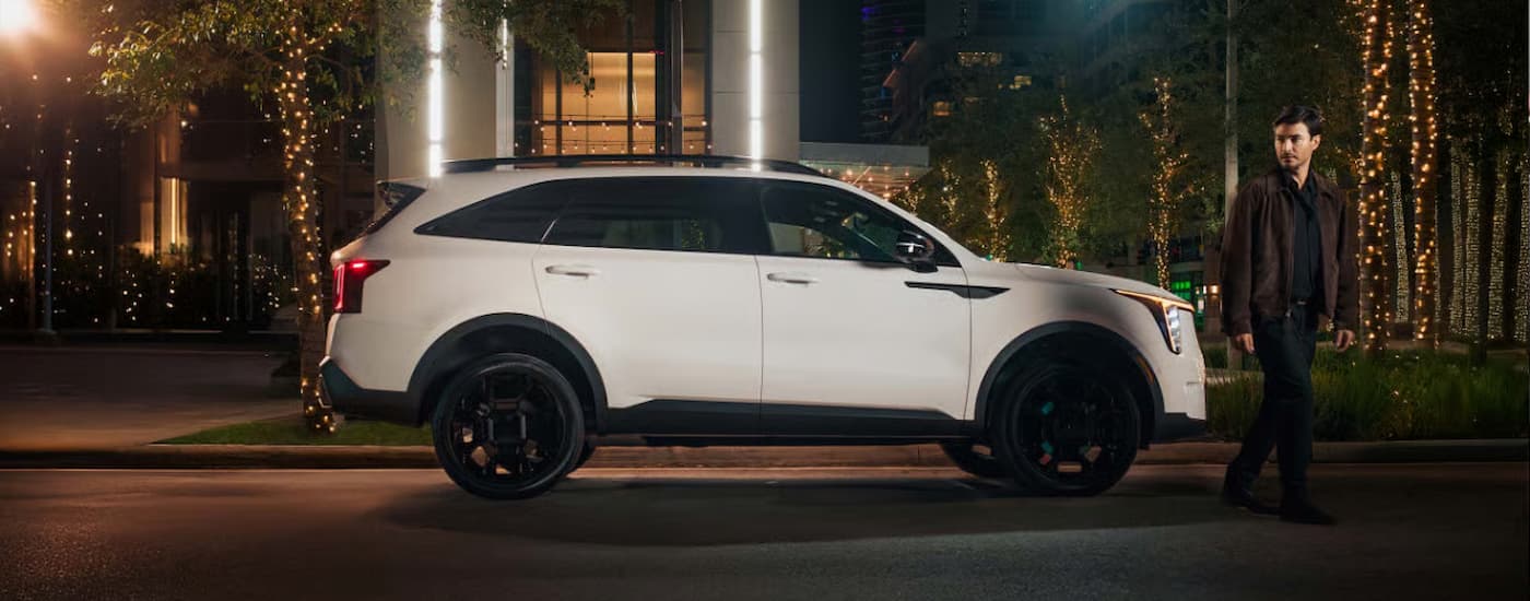 A white 2025 Kia Sorento driving in a city